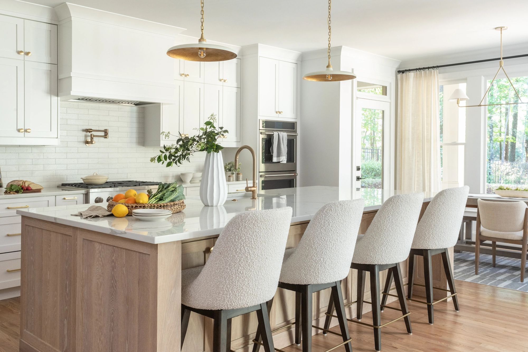 Kitchen with gold and white pendant lights.