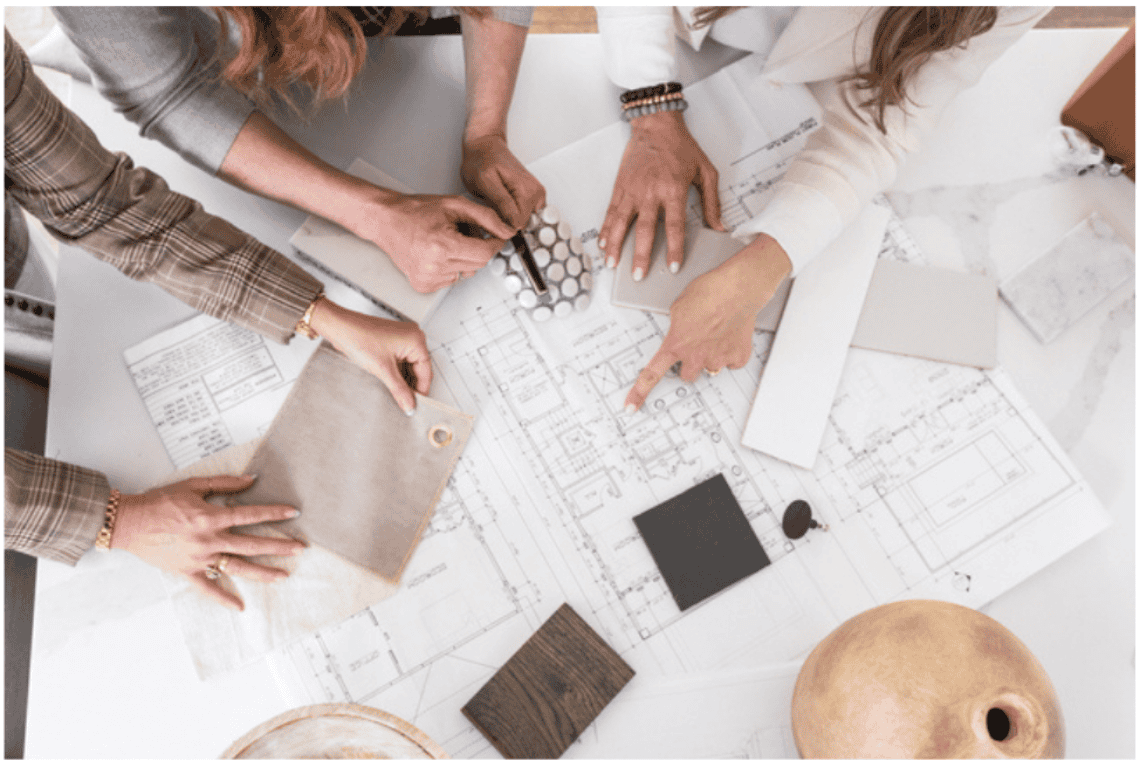 interior designers working on blueprint