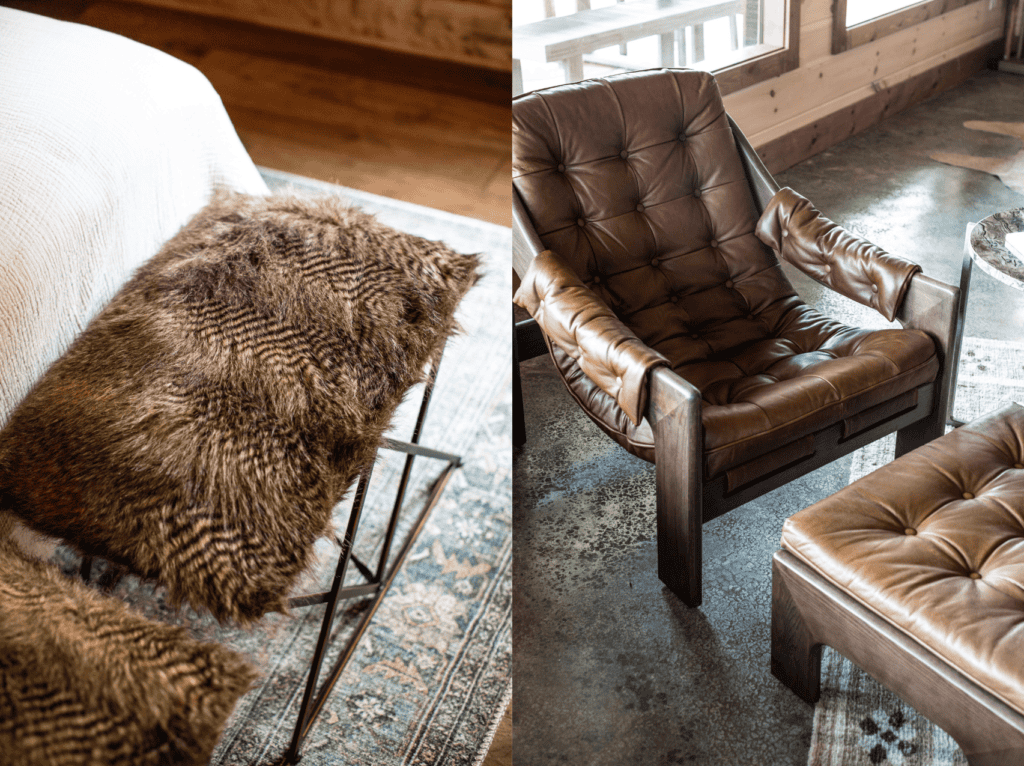 Two fur stools at the end of a bed and a brown leather chair with leather padding attached to the arms and a brown leather, rectangular ottoman in front of it.