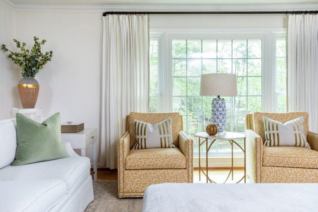 The Project Chastain living room highlights how a light neutral color scheme base prevents colors and patterns from looking busy.